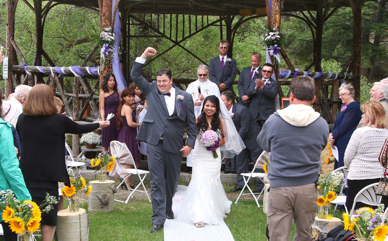 Mike and Jovyln Satterthwaite celebrate their June 11 marriage at scenic Basin Creek Reservoir near Butte, Mont., an outdoor wedding permitted under the Helena Diocese's revised policy on wedding locations. (Walter Hinick/Montana Standard)