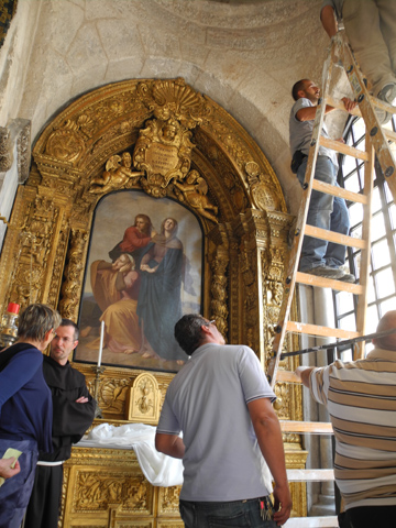 Fr. Sergio Galdi, secretary of the Franciscan Custody of the Holy Land, in the monk's habit, supervises last-minute renovations to the Chapel of St Mary of the Spasm in the Church of the Holy Sepulchre on Thursday in Jerusalem. (Melanie Lidman)