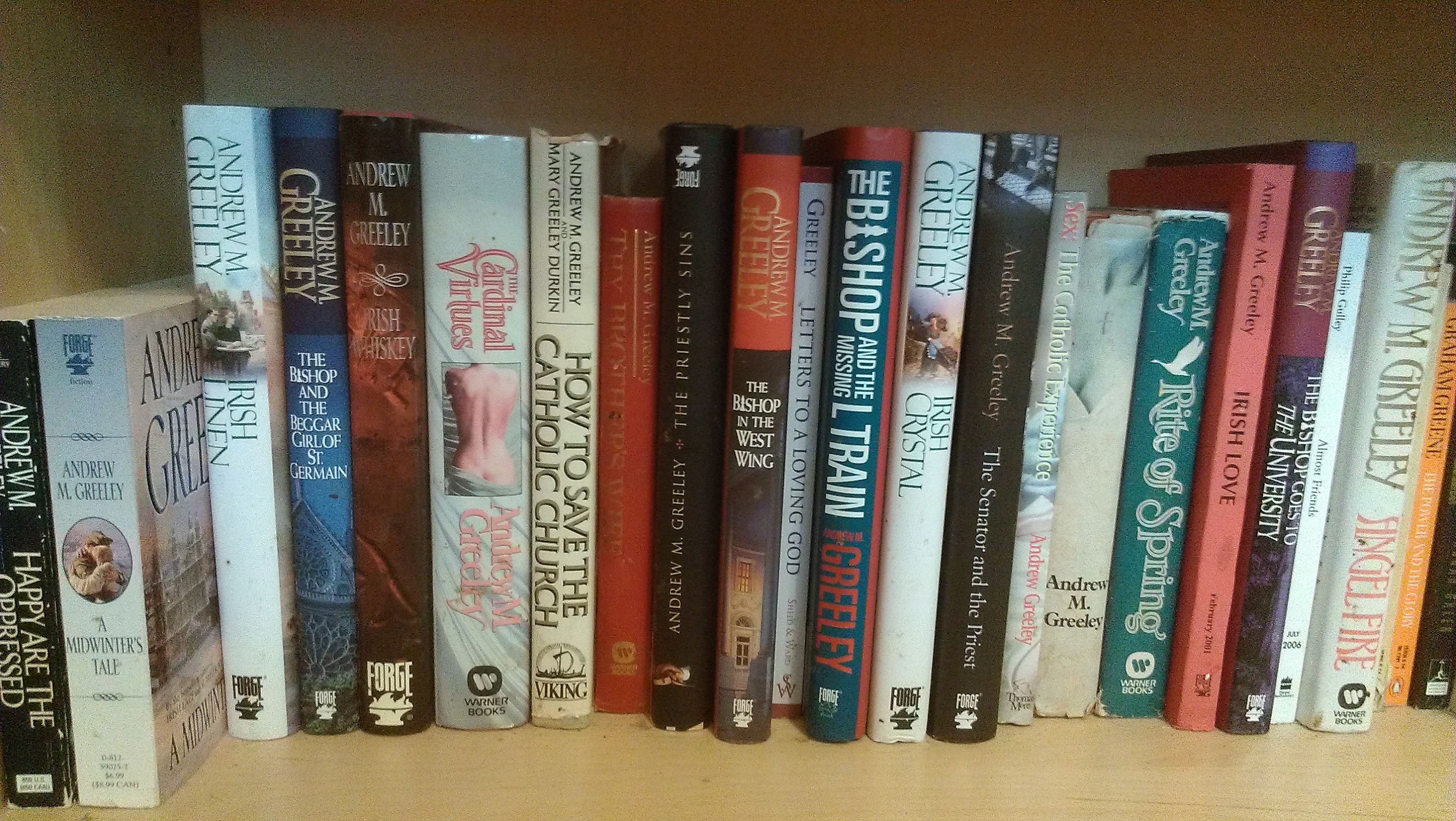 The Andrew Greeley section of my bookshelf.
