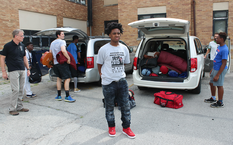 Precious Blood Fr. Dave Kelly and youth awaiting Alontae's arrival so they can leave for St. Joseph's College. (Juan Acuna)