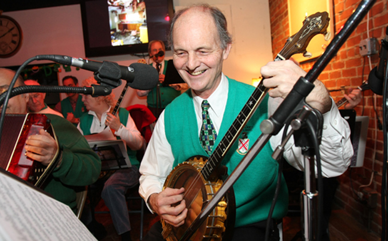 Fr. Bill Brisotti playing banjo with an Irish band at a fundraiser after the parish outreach burned in December 2007. (Provided photo)