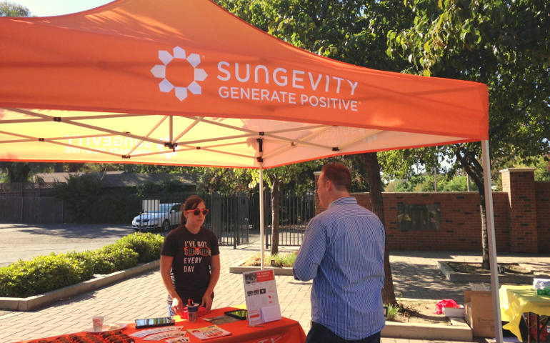Tom Hollcraft, right, speaks to a Sungevity sales rep Aug. 16 at the launch event for the Stockton, Calif., diocese's new solar panel program. Sungevity, an Oakland-based company, is one of four partners in the program. (Photo courtesy Katelyn Roedner Sutter)