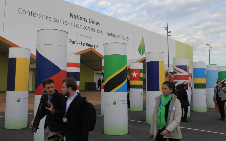Participants at COP21, held in Le Bourget, France, northwest of Paris, head toward the conference halls. The United Nations climate summit runs Nov. 30-Dec. 11 (NCR photos/Brian Roewe)
