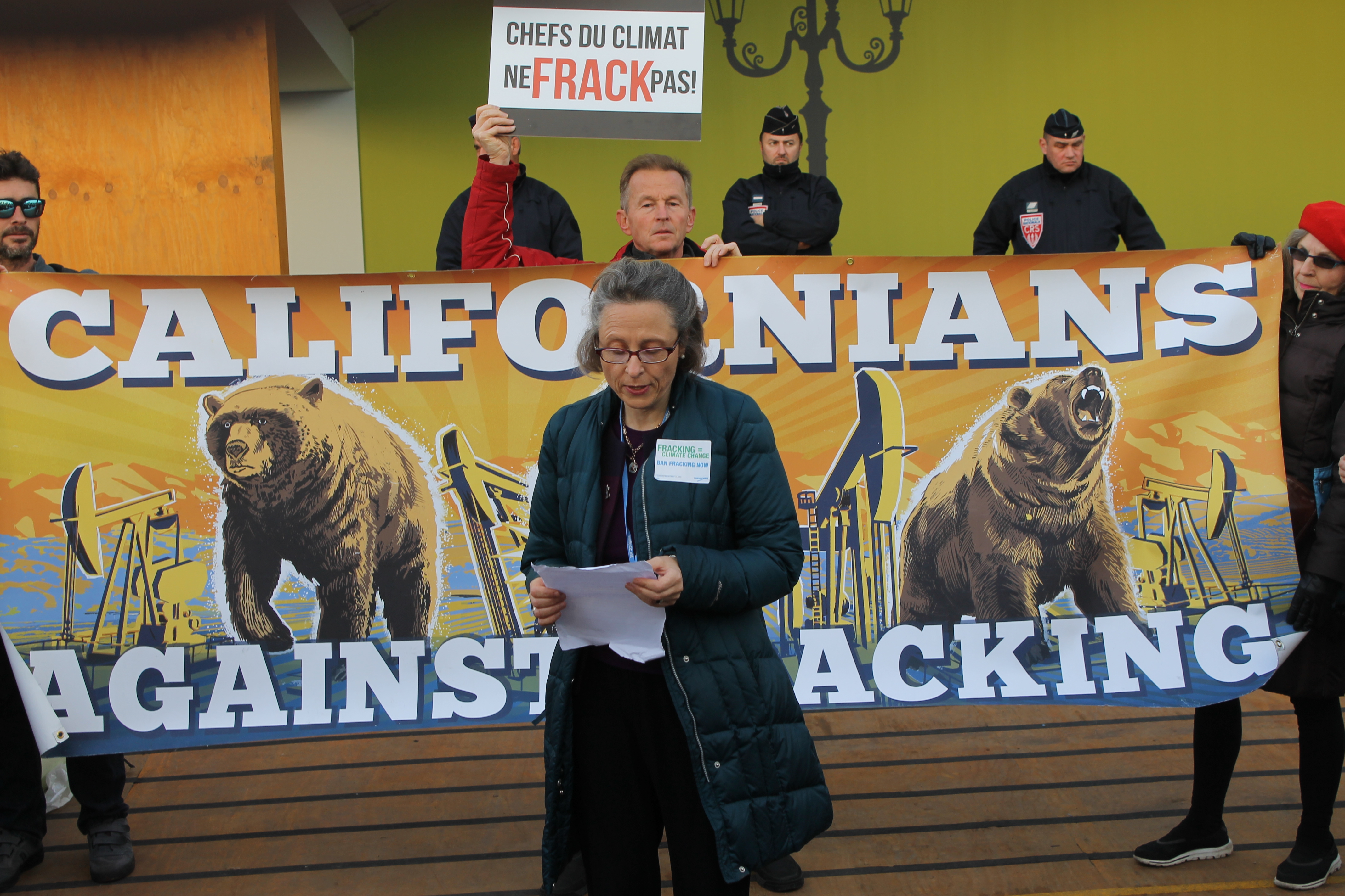 Mercy Sr. Aine O'Connor speaks at an anti-fracking rally outside the main venue of COP21 in France. (NCR photo/Brian Roewe)