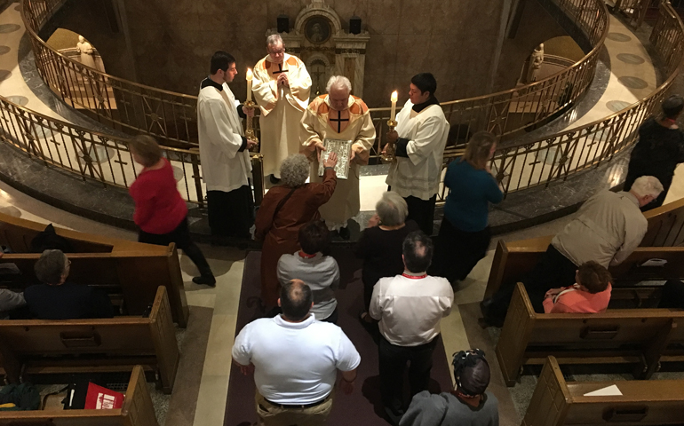 Detroit synod members take their oath of fidelity on the Book of Gospels Nov. 18 at the Opening Mass at St. Aloysius in Detroit.