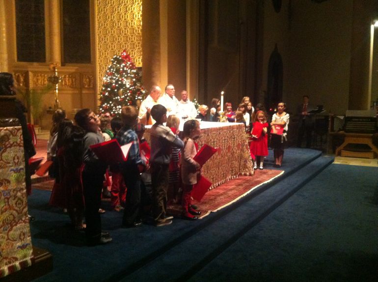 Jesuit pastor Ray Allender and Jesuit associate pastor Paul Bernadicou  and children's choir