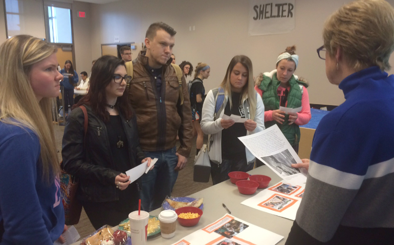 Participants at Misericordia University's exhibit learn about typical diets of people who are refugees. (Courtesy of Misericordia University campus ministry)
