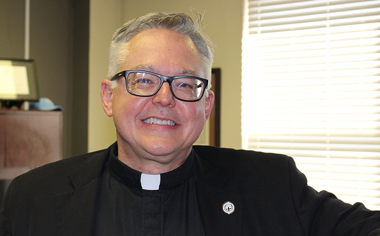 Msgr. Stuart Swetland in his office at Donnelly College in Kansas City, Kan. (NCR/Toni-Ann Ortiz)