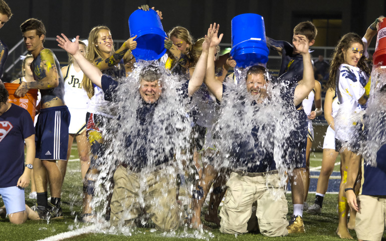 Fausin Weber, headmaster, left, and Deacon Brian Edwards, chair of the theology department at Pope John Paul II High School in Hendersonville, Tenn., were doused with ice water in the ALS "Ice Bucket Challenge" at halftime at the school's Aug. 22 football game. (CNS/Tennessee Register/Rick Musacchio)