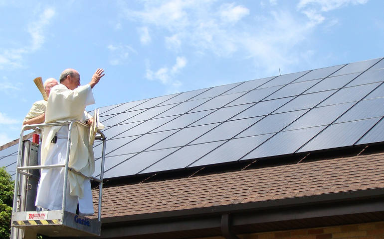 Fr. Bob Stagg, pastor at the Church of the Presentation, Upper Saddle River, N.J., blesses on June 18, 2011 solar panels installed on the church roof. The array has cut the parish's energy bill in half. (Courtesy of Church of the Presentation)