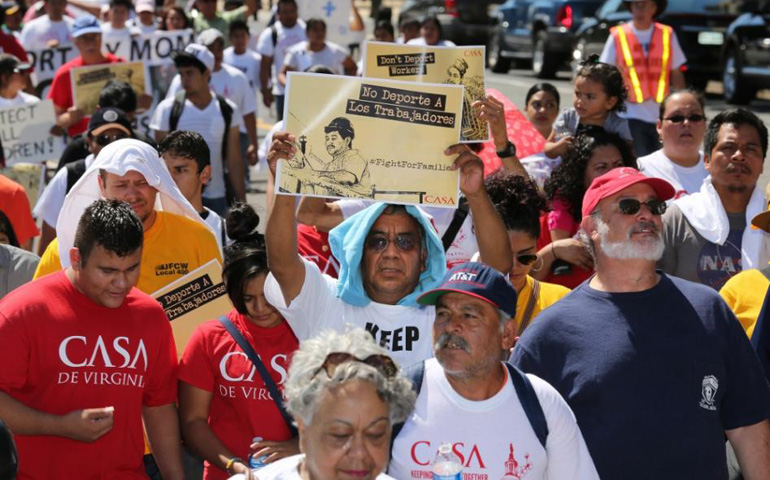 A man displays a sign during an Aug. 28 immigration march and rally near the U.S. Immigration and Customs Enforcement headquarters in Washington. (CNS/Bob Roller