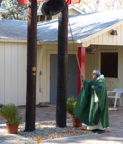 Benedictine Fr. Patrick Sheridan rings the bell for noon Mass in front of the chapel at St. Andrew's Abbey in Valyermo, Calif., Nov. 5. (CNS/Tidings/Paula Doyle)