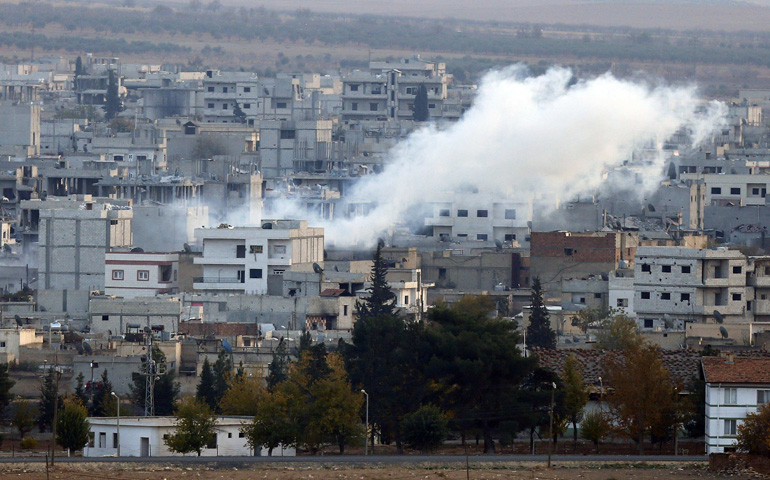 A view shows smoke rising Thursday from a Kobani, Syria, neighborhood damaged by fighting between Islamic State militants and Kurdish forces. (CNS/Reuters/Osman Orsal)
