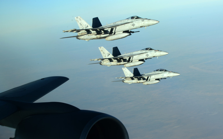 U.S. Navy fighter planes make a formation Sept. 23 over northern Iraq. These aircraft were part of a large coalition strike package that was the first to strike Islamic State targets in Syria. (CNS/EPA/Department of Defense handout) 