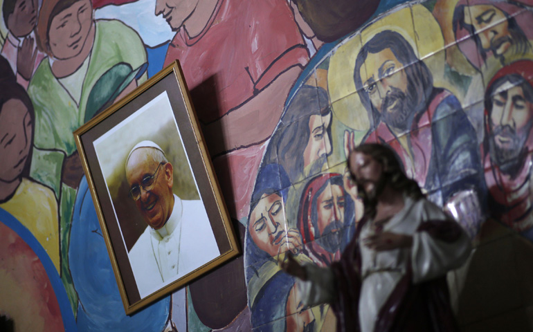 A picture of Pope Francis is seen at the altar of the Virgen de Caacupé Catholic Church during Good Friday celebrations in a Buenos Aires slum April 18, 2014, in Argentina. (Reuters/Marcos Brindicci)