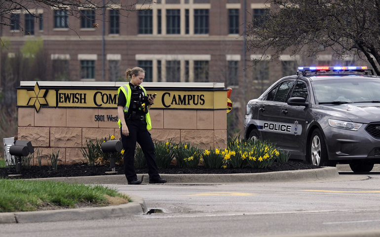 A police officer guards the entrance to the scene of a shooting Sunday at the Jewish Community Center of Greater Kansas City in Overland Park, Kan. (CNS/Reuters/Dave Kaup)