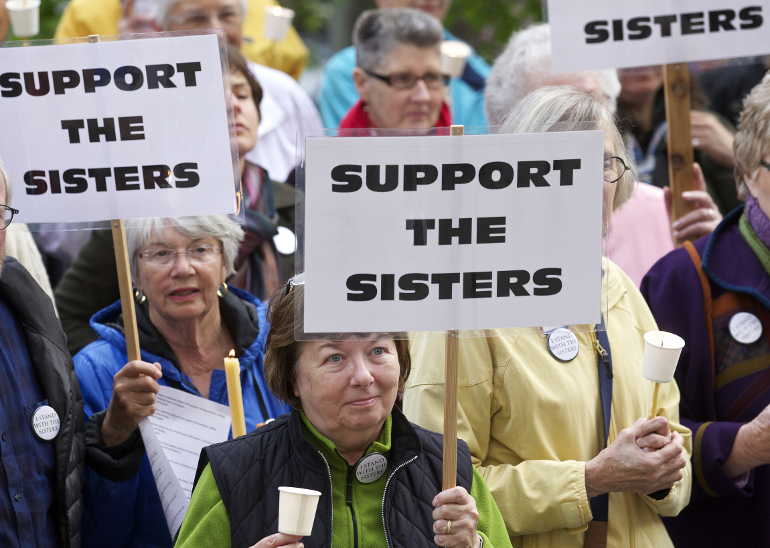 Jenner Mathiasen, center, of Seattle takes part in a vigil outside St. James Cathedral in Seattle May 8 to support sisters against the Vatican's call for a reform of the Leadership Conference of Women Religious. (CNS photo/Stephen Brashear)