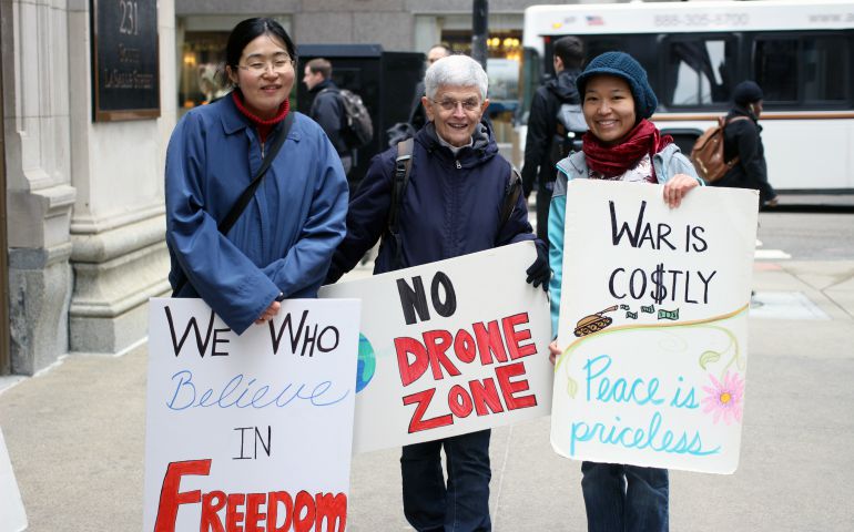 Sr. Kathleen Desautels, center, with 8th Day Center intern Elsa Loekito, right, and a friend of Loekito's at a peace vigil in 2017 (Provided photo)