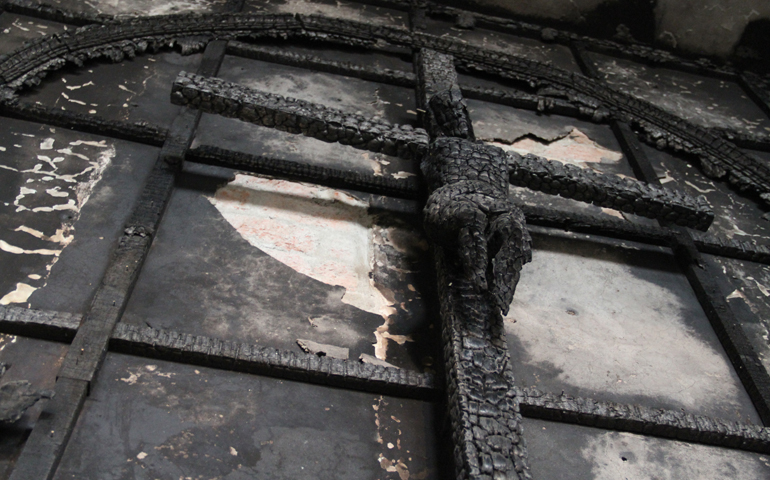 The charred crucifix at the altar of St. Sebastian's Church in Dilshad Garden, New Delhi, which was gutted by a fire on Dec. 1. (John Mathew)