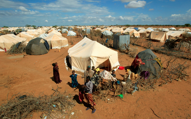 Refugees stand outside their tent in 2011 at the Ifo Extension refugee camp in Dadaab, Kenya, across the border from Somalia. (CNS photo/Thomas Mukoya, Reuters)