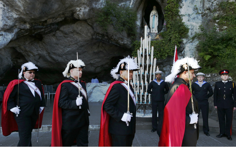A Knights of Columbus color guard leaves after a Mass during a military pilgrimage at the Shrine of Our Lady of Lourdes, May 17, 2014, in southwestern France. (CNS/Paul Haring)