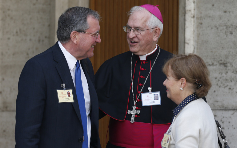 Archbishop Joseph Kurtz of Louisville, Ky., talks with Jeff and Alice Heinzen of Menomonie, Wis., as they leave the Oct. 13 morning session of the extraordinary Synod of Bishops on the family at the Vatican. (CNS/Paul Haring)