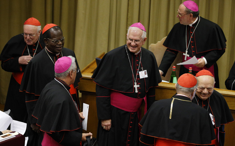 Archbishop Joseph Kurtz of Louisville, Ky., center, arrives for the afternoon session on the first working day of the extraordinary Synod of Bishops on the family Monday at the Vatican. (CNS/Paul Haring)