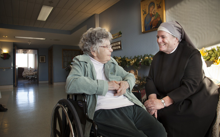 Sr. Michael Mugan visits Jan. 13 with resident Pat Austin in the hallway of the St. Louis Residence of the Little Sisters of the Poor, which serves about 100 people. (CNS/St. Louis Review/Lisa Johnston)
