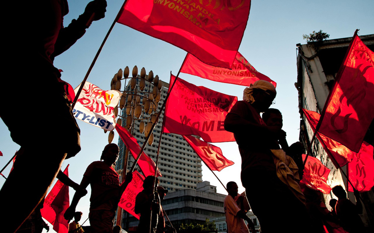 Labor groups converge in Lawton, Manila, Philippines, from various points in the city and march toward the presidential office, which police blocked off ahead of the May 1 International Labor Day protests. (Roy Lagarde)