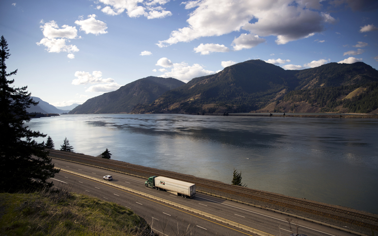 Trucks and cars make their way along the Columbia River in Oregon on Feb. 21. (CNS/Nancy Wiechec)