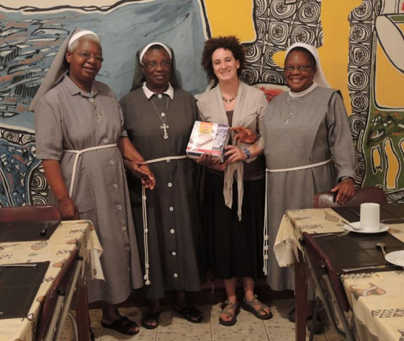 From left, Franciscans Srs. Euphrasia Chanda and Gertrude Chanda, Melanie Lidman, and Sr. Emmanuella Chilangwa with a box of matzah in the Kulandu Study Center Dining Room at the Kulandu Centre. The Chanda sisters share a last name but are not related and share administrative duties at the center. (Courtesy of Kulandu Centre)