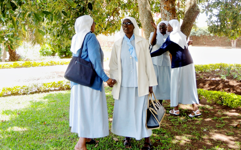Benebikira Sisters greet each other under the shade of an avocado tree at their mother house in Savé, southern Rwanda. (GSR photo / Melanie Lidman)