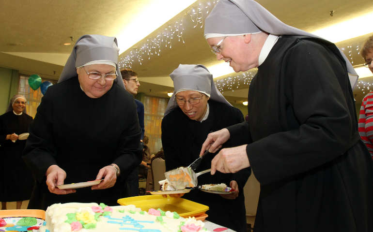 Little Sisters of the Poor prepare to distribute cake during a birthday party for centenarians Jan. 20 at the sisters' Queen of Peace Residence in the Queens borough of New York. (CNS/Gregory A. Shemitz)