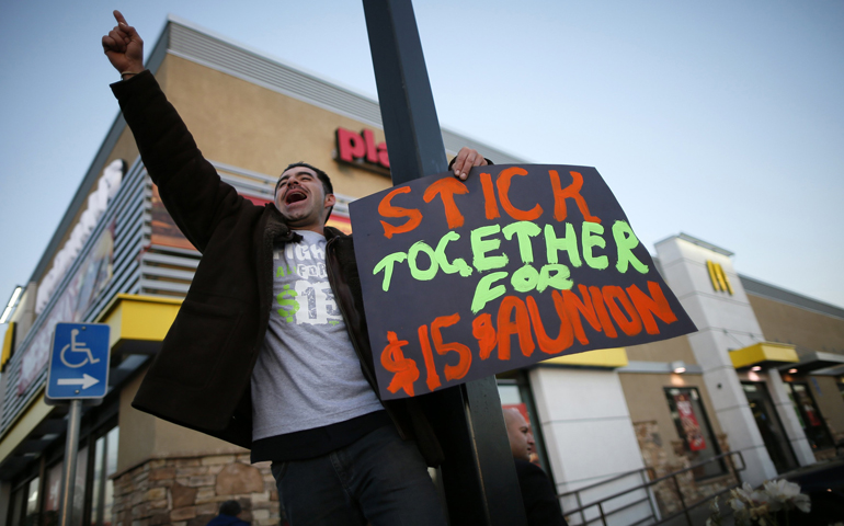 McDonald's worker Abran Escarzaga, on strike for higher pay, protests Dec. 5 outside McDonald's in Los Angeles. (CNS/Reuters/Lucy Nicholson)