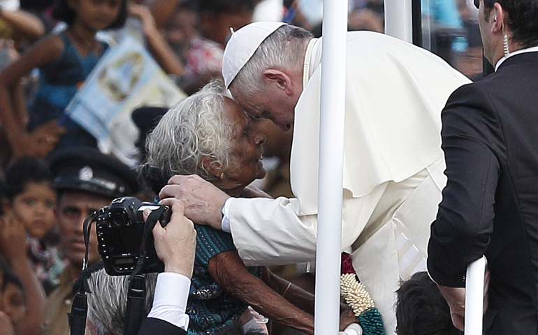 Pope Francis greets a woman as he arrives to pray Wednesday at the Sanctuary of Our Lady of the Rosary in Madhu, Sri Lanka. (CNS/Paul Haring) 