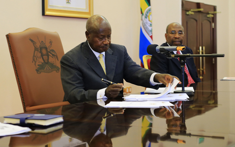 Uganda President Yoweri Museveni signs an anti-homosexuality bill into law Feb. 24 in Entebbe. (CNS/Reuters/James Akena)