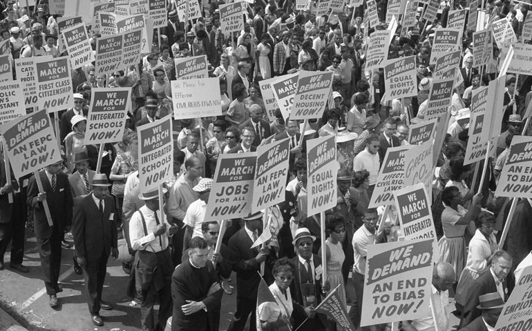 Demonstrators holding signs march during the 1963 March on Washington. (CNS/Library of Congress) 