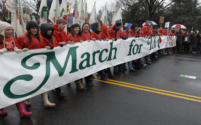 Young people walk with a banner at the start of the annual March for Life on Jan. 23, 2012, in Washington. (CNS/Bob Roller)