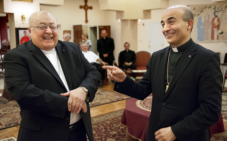 Retiring Bishop Robert Shaheen, left, of the U.S. Maronite Eparchy of Our Lady of Lebanon, shares a light moment with his successor, Bishop-designate Abdallah Zaidan, July 12 at the Maronite Pastoral Center in St. Louis. (CNS/Sid Hastings) 