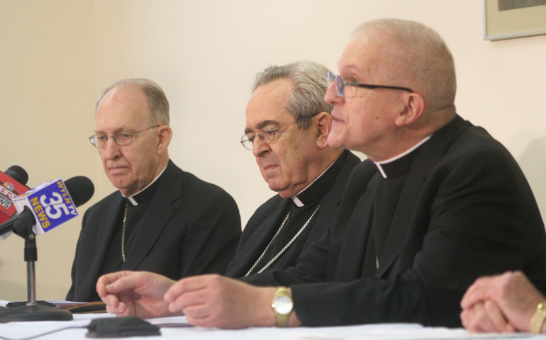 Bishop Joseph Martino, right, speaks at a news conference Aug. 31 about his resignation. At left is retiring Scranton Auxiliary Bishop John Dougherty and Philadelphia Cardinal Justin Rigali, center, who has been appointed apostolic administrator of Scranton. (CNS photo)