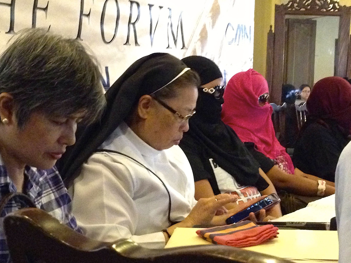 Benedictine Sr. Mary John Mananzan, OSB, takes notes during the sharing on abuse distressed Filipino house help allegedly suffered while working and after fleeing abusive employers at a forum here Feb. 18.  (N.J. Viehland)