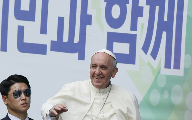 Pope Francis greets the crowd as he arrives Friday to celebrate Mass on the feast of the Assumption in World Cup Stadium in Daejeon, South Korea. (CNS/Paul Haring) 