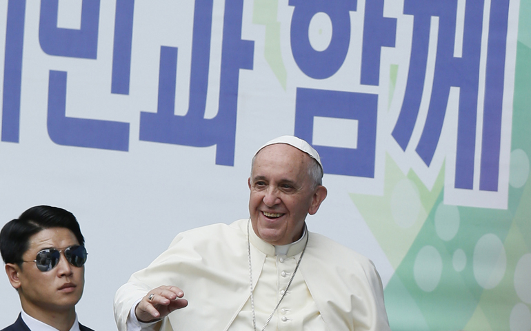 Pope Francis greets the crowd as he arrives Friday to celebrate Mass on the feast of the Assumption in World Cup Stadium in Daejeon, South Korea. (CNS/Paul Haring)