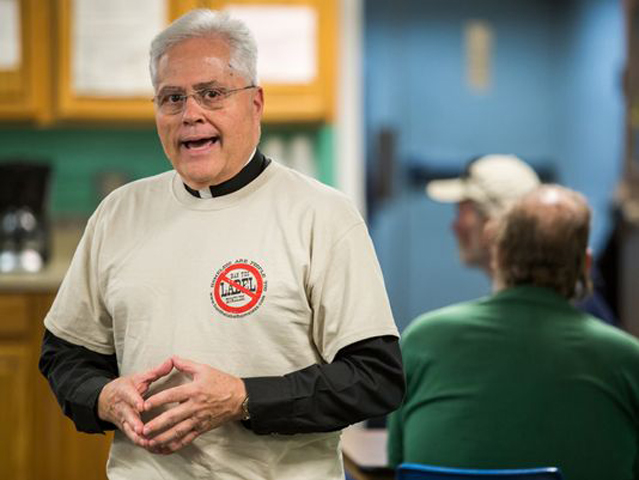Fr. Paul Mast speaks to homeless men at St. Andrew's Place, one of the shelters he stayed at during a six-month sabbatical on Oct. 6, 2014, in Wilmington, Del. (The News Journal/Keyle Grantham)
