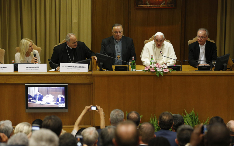 Pope Francis addresses a workshop on climate change and human trafficking attended by mayors from around the world Tuesday in the synod hall at the Vatican. Also at the workshop, from left: Argentine model Valeria Mazza, serving as master of ceremonies; Bishop Marcelo Sanchez Sorondo, chancellor of the Pontifical Academy of Sciences; Cardinal Francesco Montenegro of Agrigento, Italy; and Cardinal Claudio Hummes, former prefect of the Congregation for the Clergy. (CNS/Paul Haring)