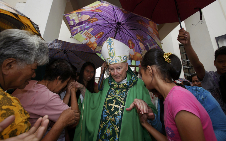 People greet Cardinal Theodore McCarrick after a Nov. 17 Mass inside Cathedral of the Transfiguration of Our Lord in Palo, Philippines, which was heavily damaged by Typhoon Haiyan.  (CNS/Reuters/Bobby Yip)