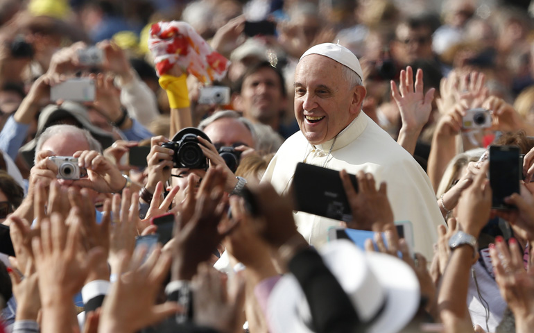 Pope Francis greets the crowd as he arrives to lead his general audience in St. Peter's Square at the Vatican Oct. 1. (CNS/Paul Haring)