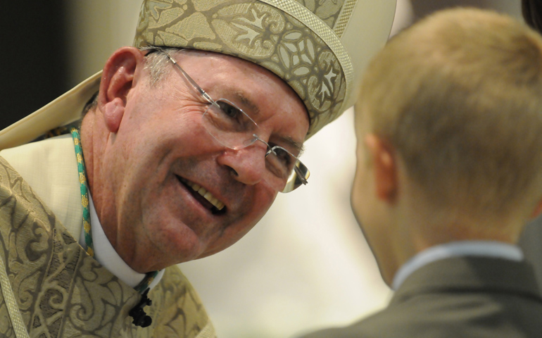 Bishop Joseph McFadden is greeted by a young boy who was one of the representatives of the community who welcomed him during his 2010 installation Mass at St. Patrick's Cathedral in Harrisburg. (CNS/The Catholic Witness/Emily M. Albert)