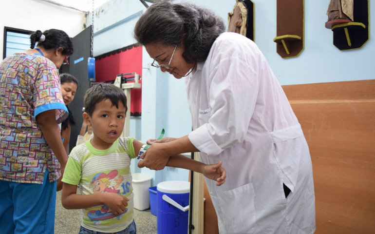 A doctor measures the arms of a child attending the local SAMAN nutrition clinic, a partnership between sisters of Our Lady of the Immaculate Conception of Castres and Caritas Internationalis. (GSR photo/Cody Weddle)