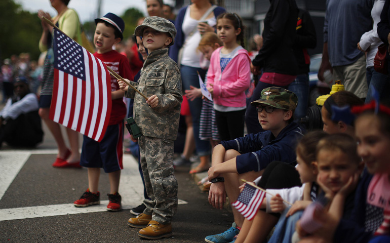 Children watch a Memorial Day parade in Boston on May 26, 2014. (Newscom/Reuters/Brian Snyder)